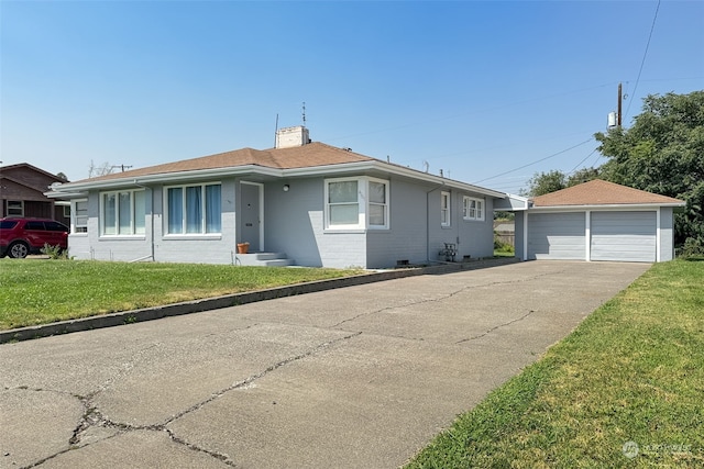 view of front of property with an outbuilding, a garage, and a front yard