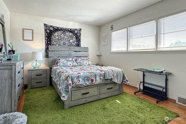 bedroom with hardwood / wood-style flooring