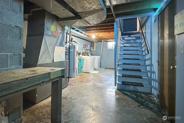 basement featuring separate washer and dryer and water heater