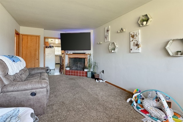 living room featuring carpet and a fireplace