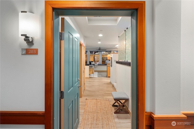 corridor with light hardwood / wood-style flooring