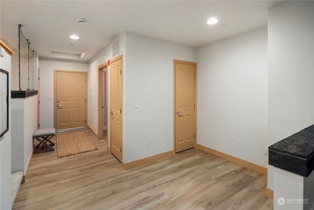 hall with light hardwood / wood-style floors