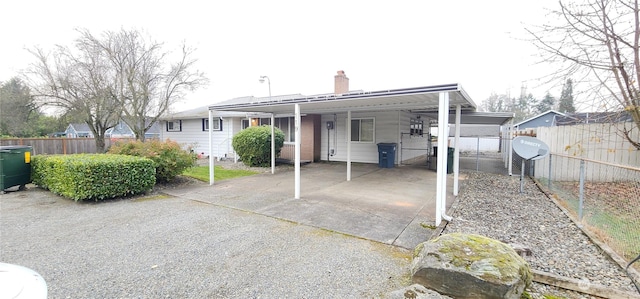 rear view of property with a carport