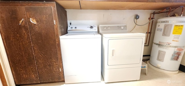 clothes washing area with washing machine and clothes dryer and water heater