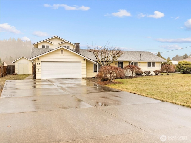 view of front of property with driveway, a garage, fence, a shed, and a front yard