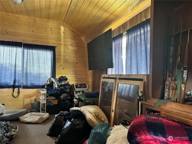 bedroom with vaulted ceiling, wooden ceiling, and wood walls