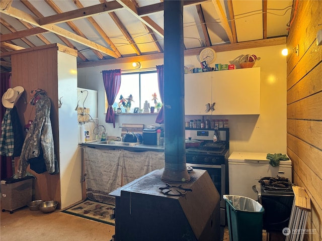 miscellaneous room with sink, concrete flooring, and lofted ceiling