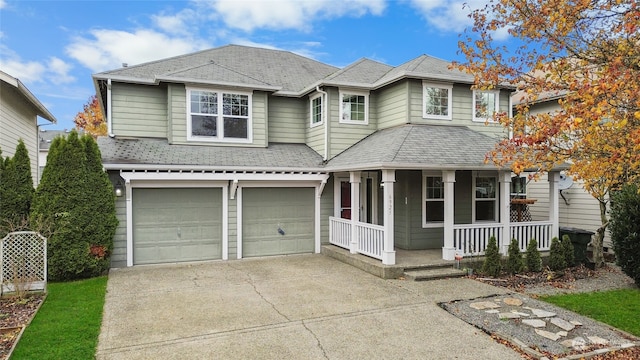 view of property featuring covered porch and a garage