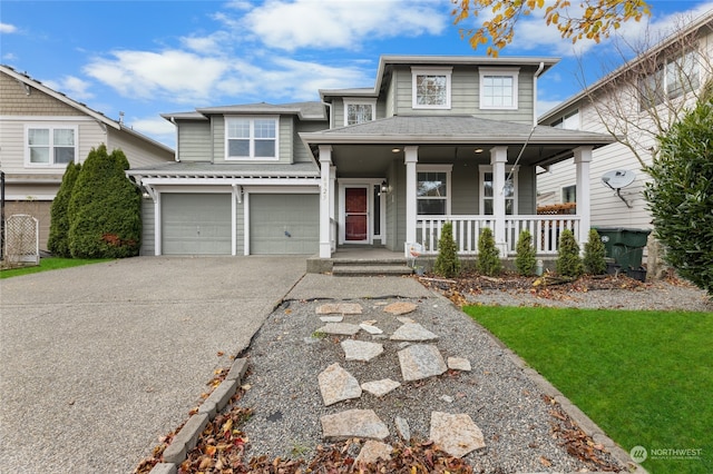 view of front facade with a front lawn, a porch, and a garage