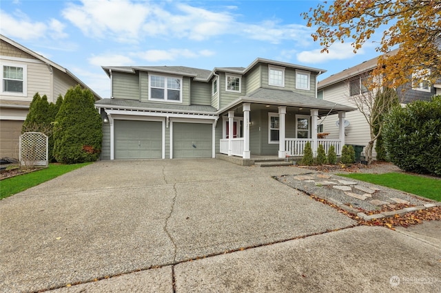 view of front of home with covered porch and a garage