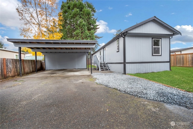 view of home's exterior with a carport and a lawn