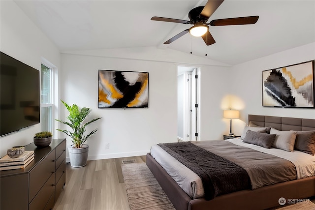 bedroom featuring ceiling fan, vaulted ceiling, and light wood-type flooring