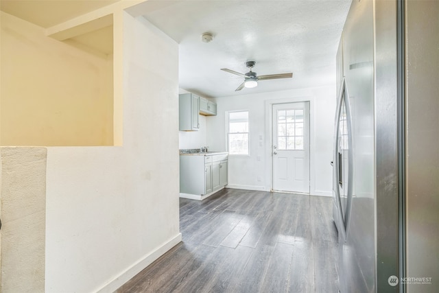 interior space with ceiling fan and dark hardwood / wood-style flooring