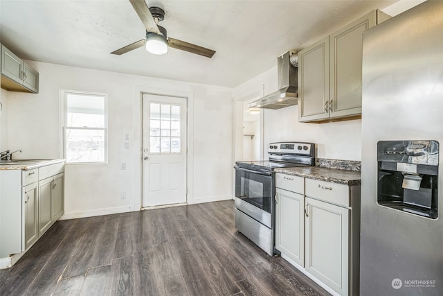 kitchen featuring gray cabinets, wall chimney exhaust hood, dark hardwood / wood-style floors, and appliances with stainless steel finishes