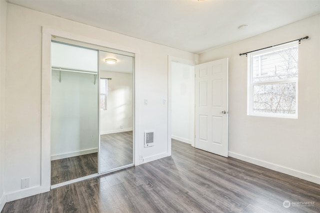 unfurnished bedroom with hardwood / wood-style floors and a closet