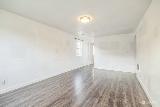 empty room featuring dark hardwood / wood-style flooring