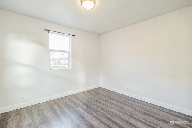 spare room with hardwood / wood-style floors