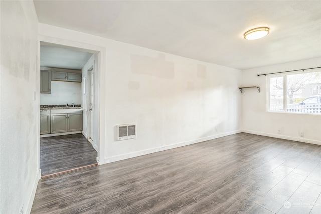 spare room featuring dark hardwood / wood-style flooring and sink