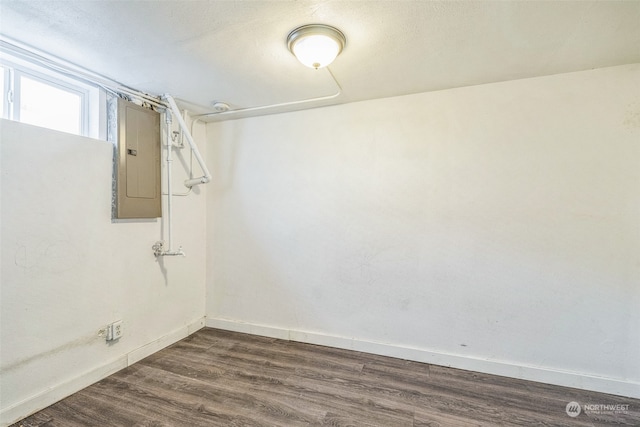 interior space with electric panel and dark wood-type flooring