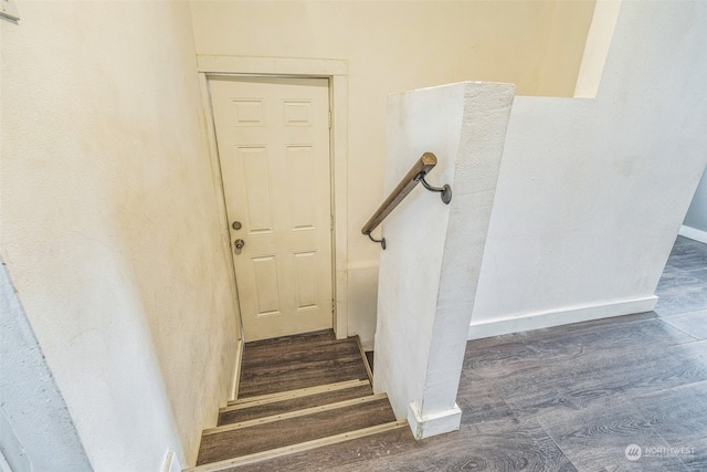 stairs featuring wood-type flooring