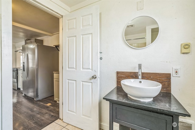 bathroom with hardwood / wood-style flooring and vanity