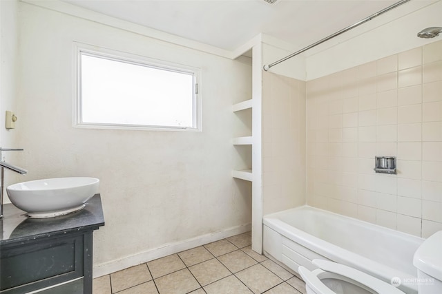 full bathroom with vanity, tile patterned flooring, tiled shower / bath, and toilet