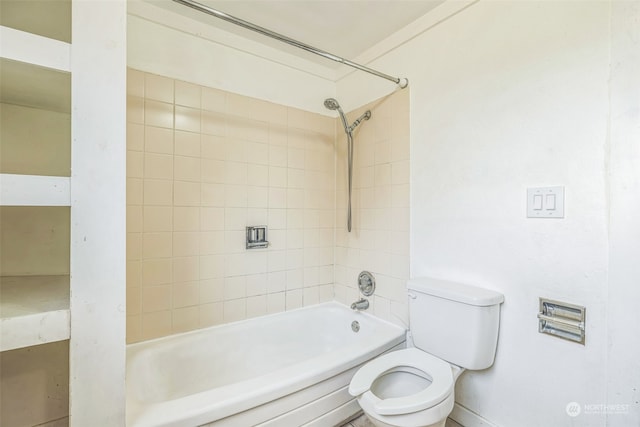 bathroom featuring toilet and tiled shower / bath