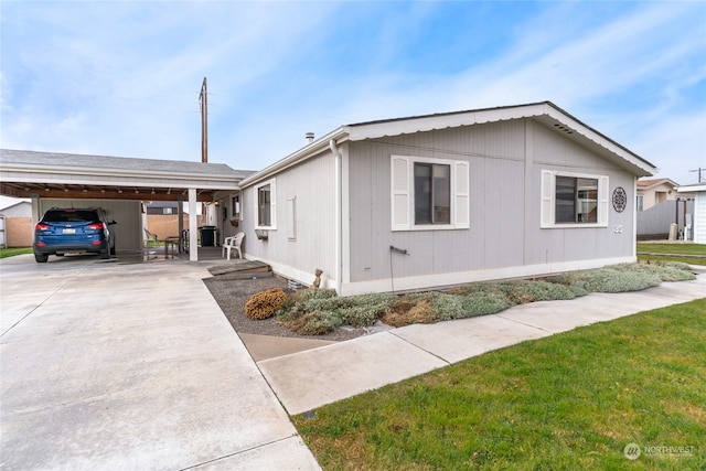 view of property exterior with a yard and a carport