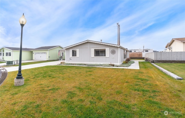 single story home featuring central AC unit, a front lawn, and a garage