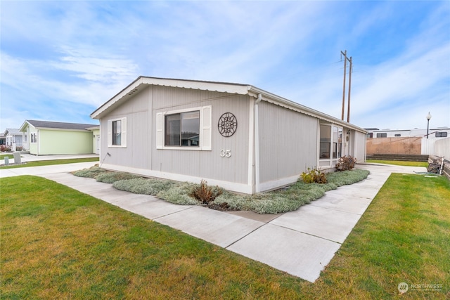 view of home's exterior with a lawn