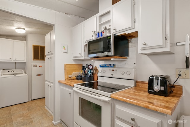 kitchen with white cabinets, washer / dryer, and electric stove