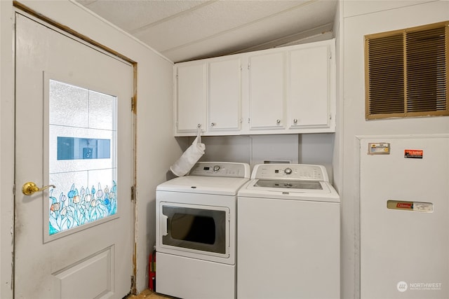 laundry room with washer and clothes dryer and cabinets