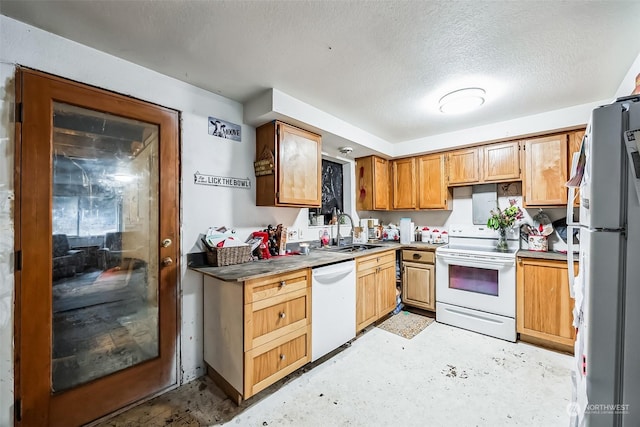 kitchen with a textured ceiling, sink, and white appliances