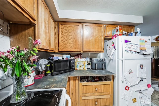 kitchen featuring white fridge and range