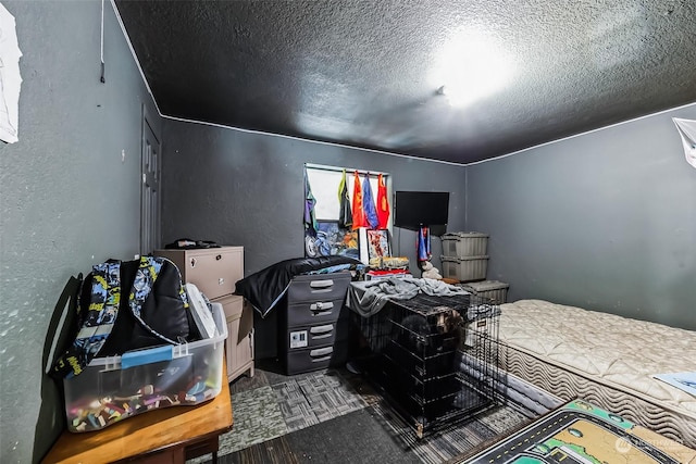 bedroom featuring dark hardwood / wood-style floors and a textured ceiling