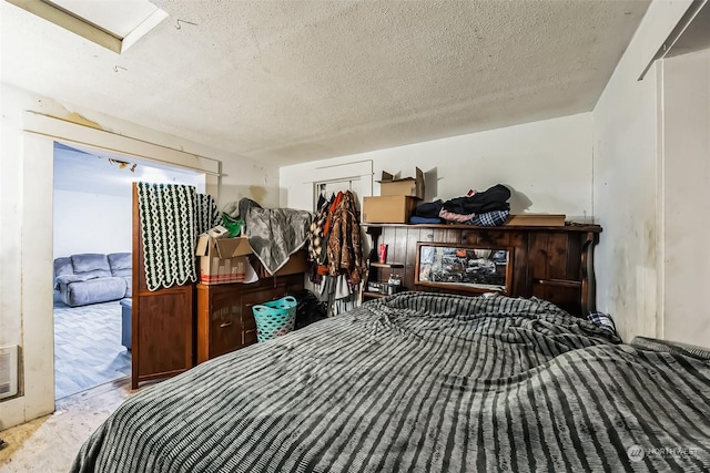 bedroom featuring access to exterior and a textured ceiling