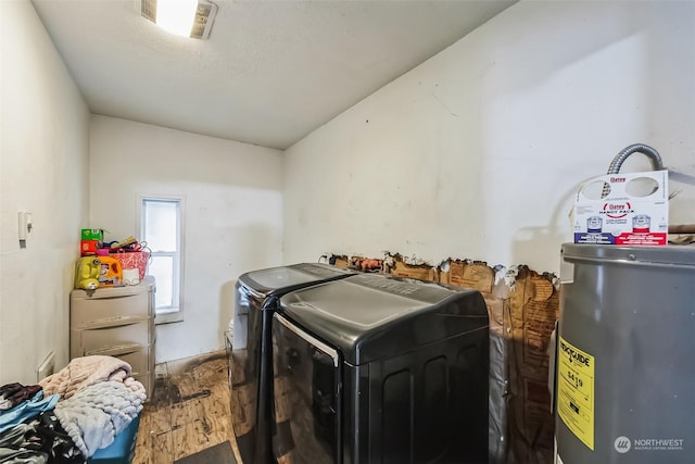 clothes washing area with washer and dryer and electric water heater