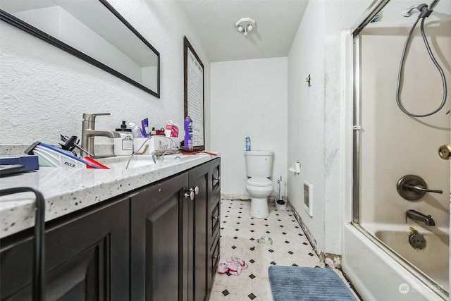 full bathroom featuring vanity, toilet, and shower / bath combination with glass door