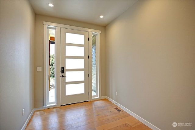 foyer entrance with light hardwood / wood-style floors