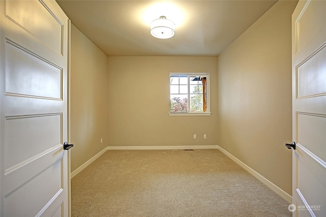 unfurnished room with light carpet