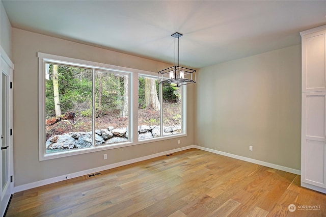 unfurnished dining area featuring plenty of natural light and light hardwood / wood-style flooring