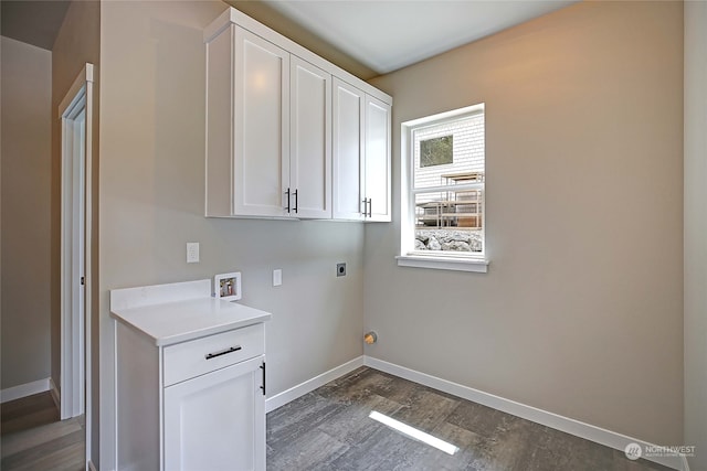 clothes washing area featuring hookup for an electric dryer, dark hardwood / wood-style flooring, cabinets, and hookup for a washing machine