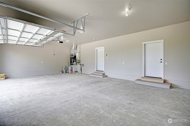 garage with gas water heater and a garage door opener