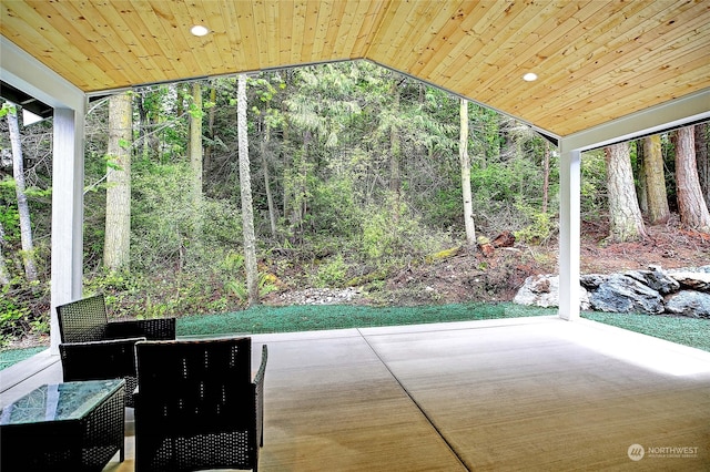 unfurnished sunroom with wood ceiling and vaulted ceiling