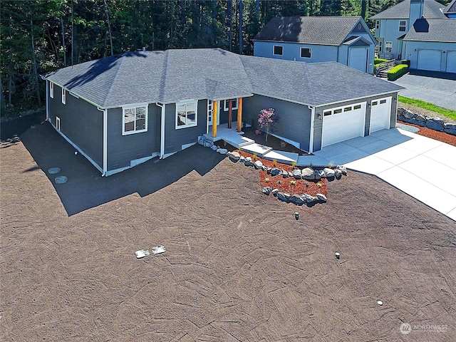 view of front of home with a porch and a garage