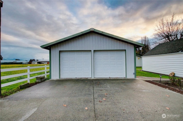 garage at dusk with a lawn