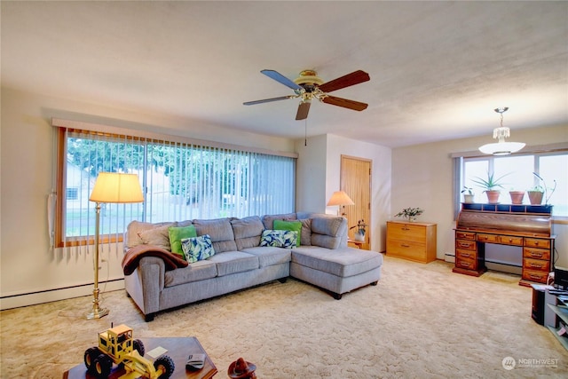 carpeted living room with ceiling fan and a baseboard radiator