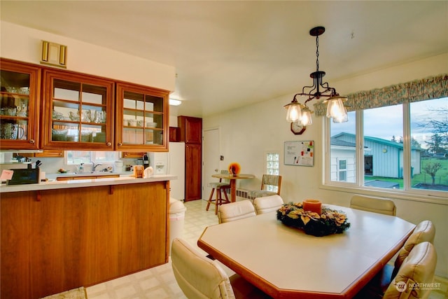 dining area with an inviting chandelier and sink