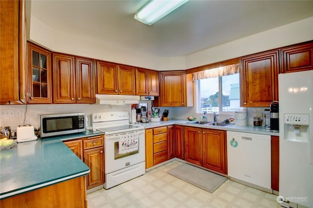 kitchen with sink and white appliances