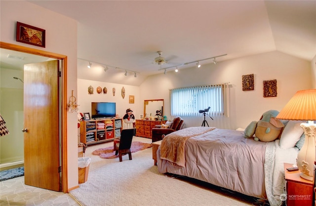 carpeted bedroom featuring ceiling fan, rail lighting, and vaulted ceiling